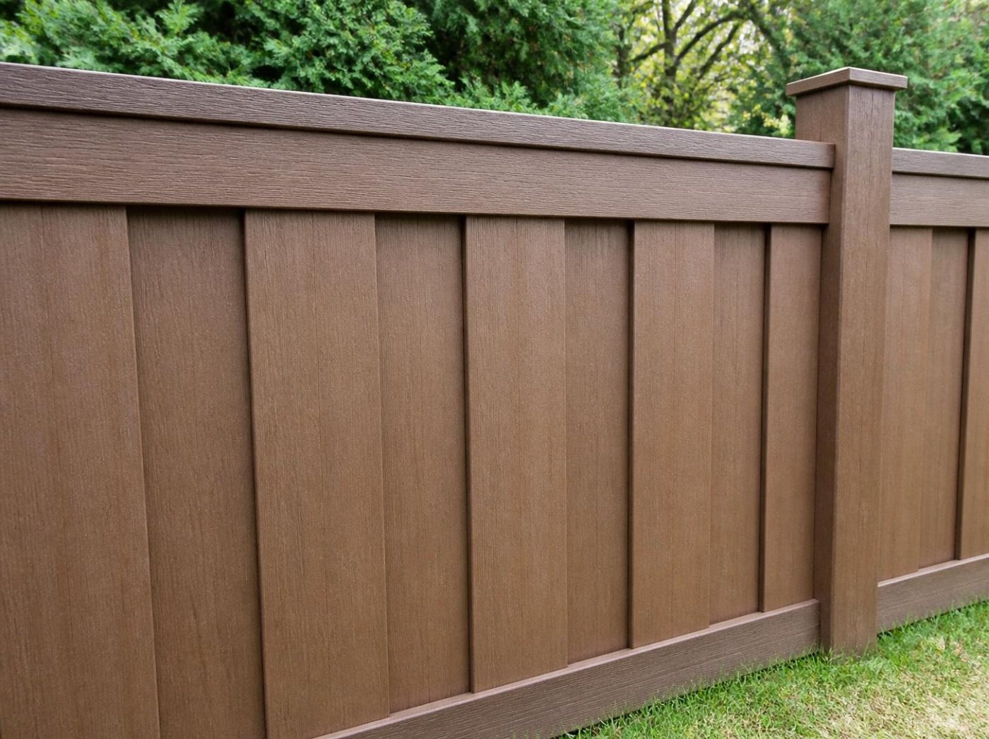 Brown composite privacy fence with a top cap and matching post